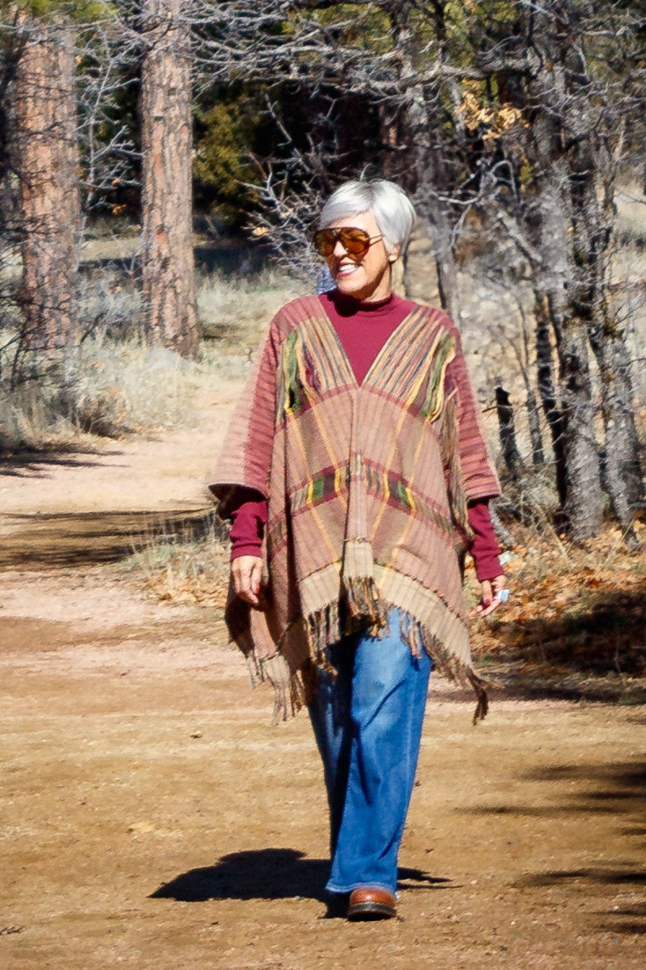 Poncho con textil 100% artesanal tejido en telar de pedal con deshuilados mediano en franjas en todo  lo alto. De corte oversize con cuello en V y flecos en la parte inferior.